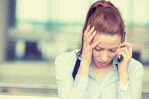 Portrait unhappy young woman talking on mobile phone looking down. Human face expression, emotion, bad news reaction